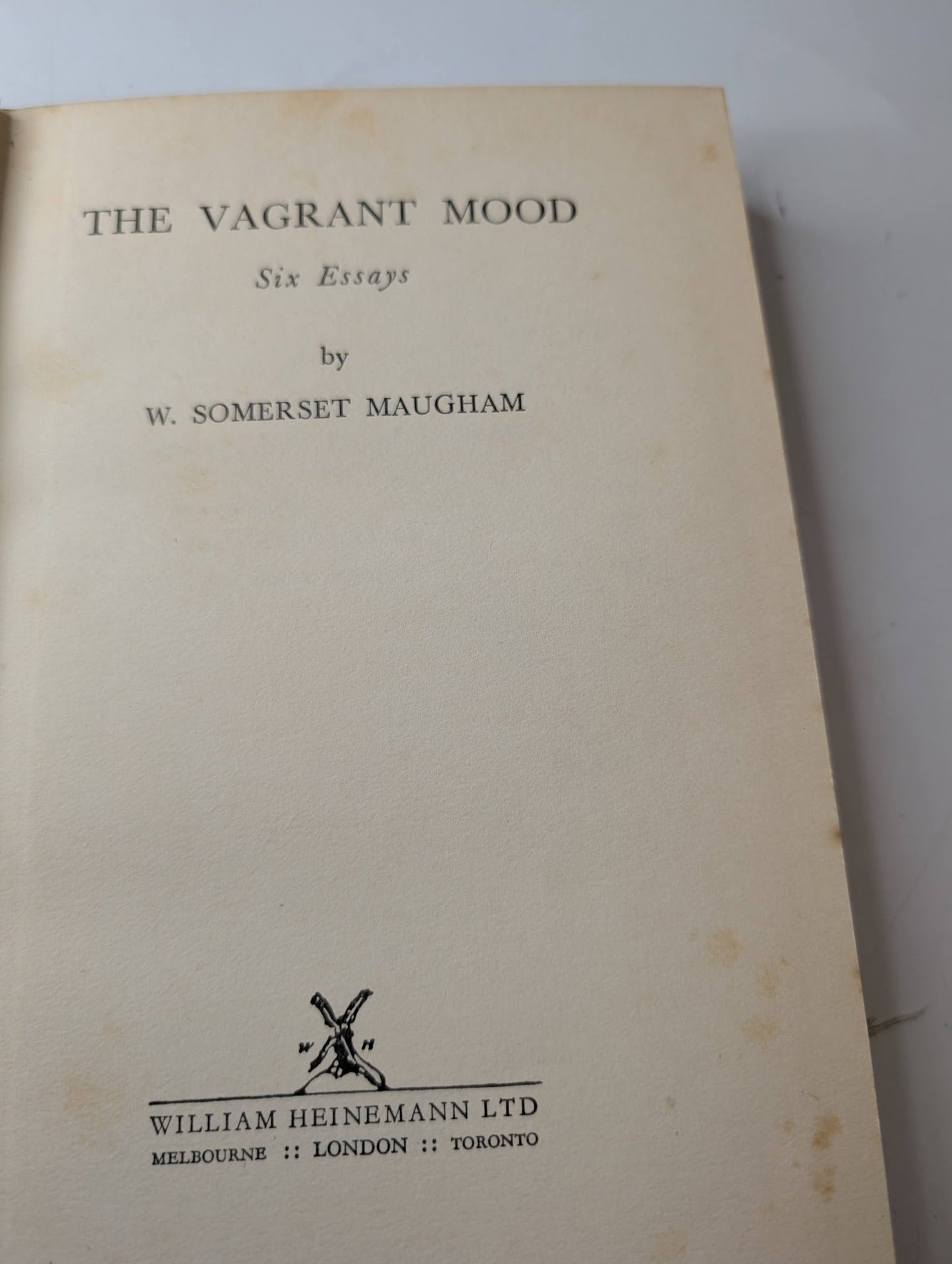 Book titled 'The Vagrant Mood' by W. Somerset Maugham with William Heinemann Ltd on a white background